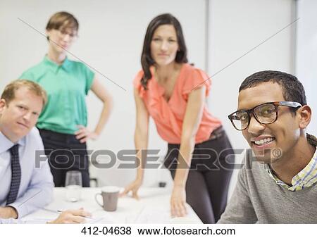 Stock Photo - Business people smiling in meeting. Fotosearch
