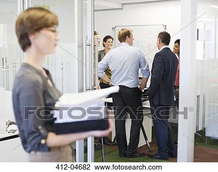 Stock Image - Business people talking in meeting. Fotosearch
