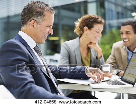 Business people talking outdoors View Large Photo Image Stock Photo - Business people talking outdoors. Fotosearch