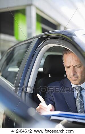 Businessman working in car View Large Photo Image Stock Image - Businessman working in car. Fotosearch