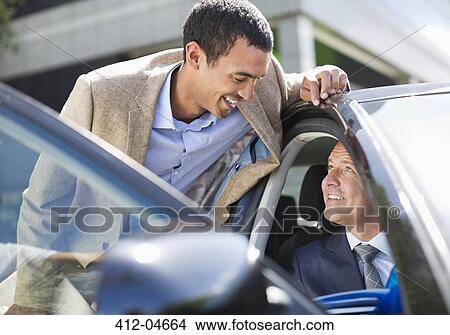 Picture - Businessmen talking in car. Fotosearch