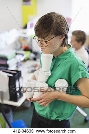Businesswoman balancing coffee cups in office View Large Photo Image Stock Image - Businesswoman balancing coffee cups in office. Fotosearch