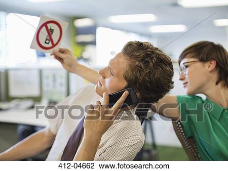 Businesswoman showing? no cell phones? sign to colleagu View Large Photo Image Stock Image - Businesswoman showing? no cell phones? sign to colleagu. Fotosearch