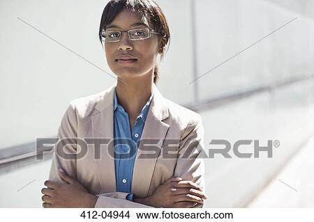 Businesswoman standing with arms crossed View Large Photo Image Picture - Businesswoman standing with arms crossed. Fotosearch