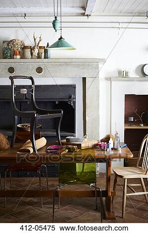 Stock Photography - Chair with upholstery supplies on table. Fotosearch