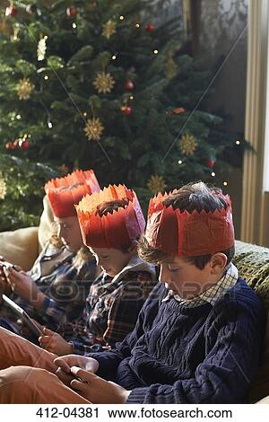 Children in paper crowns relaxing on sofa View Large Photo Image Stock Image - Children in paper crowns relaxing on sofa. Fotosearch
