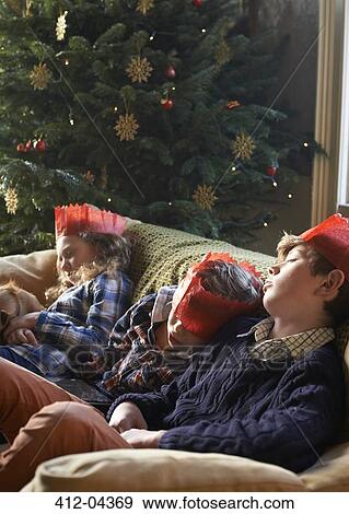 Children in paper crowns sleeping on sofa View Large Photo Image Stock Photo - Children in paper crowns sleeping on sofa. Fotosearch