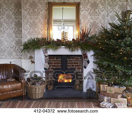 Stock Image - Christmas tree and fireplace in living room. Fotosearch