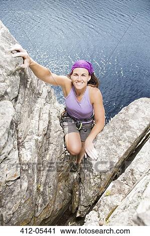Climber scaling rock face View Large Photo Image Stock Image - Climber scaling rock face. Fotosearch