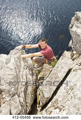 Climber scaling rock formation View Large Photo Image Stock Photograph - Climber scaling rock formation. Fotosearch