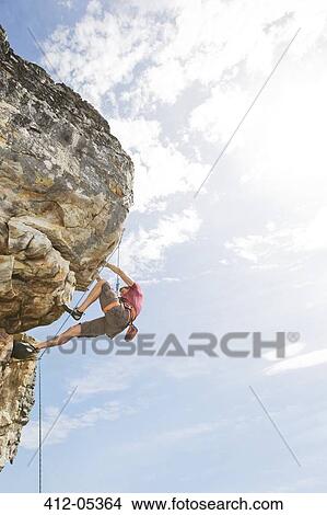 Climber scaling steep rock face View Large Photo Image Picture - Climber scaling steep rock face. Fotosearch