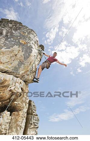 Climber scaling steep rock face View Large Photo Image Stock Image - Climber scaling steep rock face. Fotosearch
