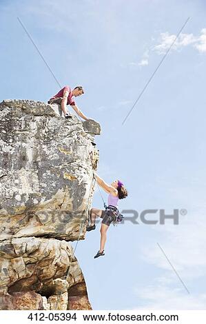Picture - Climbers scaling steep rock face. Fotosearch