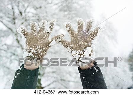Stock Photo - Close up of snowy gloves. Fotosearch