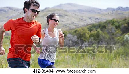 Picture - Couple running in rural landscape. Fotosearch