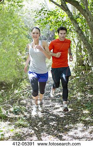 Couple running on dirt path View Large Photo Image Stock Image - Couple running on dirt path. Fotosearch