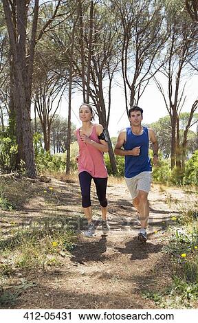 Couple running on dirt path View Large Photo Image Stock Image - Couple running on dirt path. Fotosearch