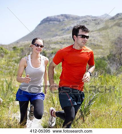 Couple running on dirt path View Large Photo Image Stock Photography - Couple running on dirt path. Fotosearch