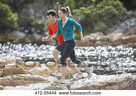 Couple running on rock formations View Large Photo Image Picture - Couple running on rock formations. Fotosearch