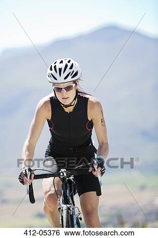 Stock Photograph - Cyclist on rural road. Fotosearch