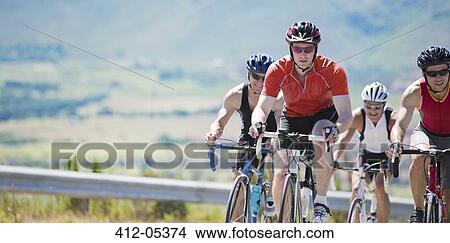 Cyclists in race on rural road View Large Photo Image Picture - Cyclists in race on rural road. Fotosearch