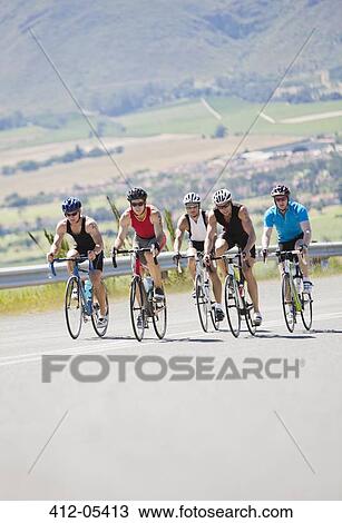 Cyclists in race on rural road View Large Photo Image Stock Image - Cyclists in race on rural road. Fotosearch