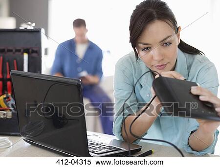 Female electrician working on laptop in home View Large Photo Image Stock Photography - Female electrician working on laptop in home. Fotosearch