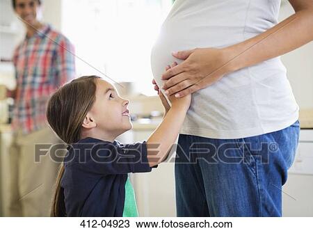 Girl holding pregnant mother's bell View Large Photo Image Stock Image - Girl holding pregnant mother's bell. Fotosearch