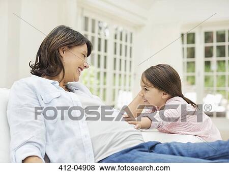 Girl holding pregnant mother's bell View Large Photo Image Stock Photo - Girl holding pregnant mother's bell. Fotosearch