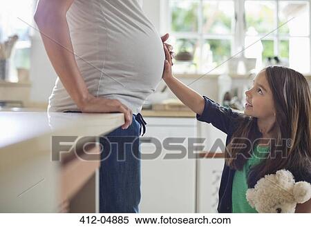 Girl holding pregnant mother's bell View Large Photo Image Stock Photography - Girl holding pregnant mother's bell. Fotosearch