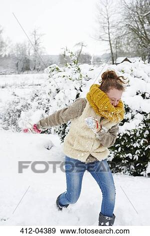 Stock Photo - Girl playing in snow. Fotosearch