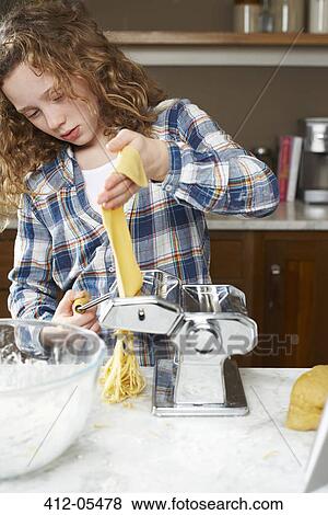 Girl rolling pasta dough in kitchen View Large Photo Image Stock Photo - Girl rolling pasta dough in kitchen. Fotosearch