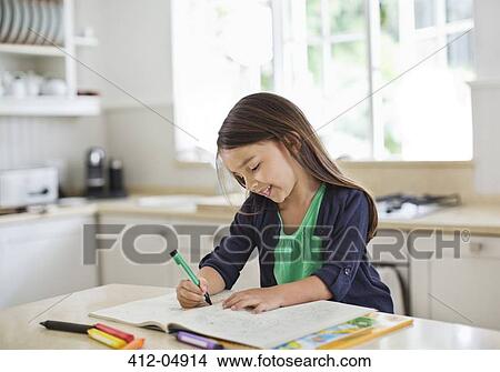 Girl using coloring book in kitchen View Large Photo Image Picture - Girl using coloring book in kitchen. Fotosearch