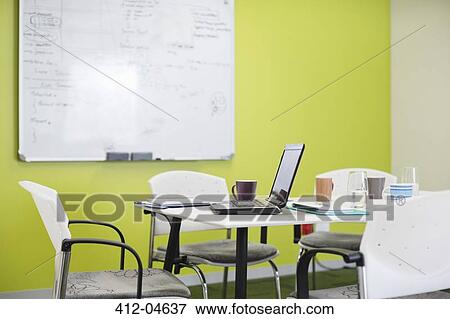 Stock Photo - Laptop and coffee cups on meeting table. Fotosearch