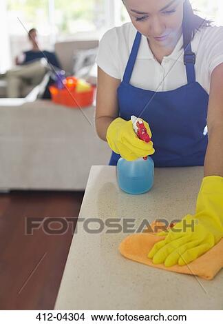 Maid cleaning kitchen counter View Large Photo Image Picture - Maid cleaning kitchen counter. Fotosearch