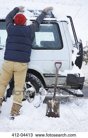 Man digging car out of snow View Large Photo Image Stock Image - Man digging car out of snow. Fotosearch