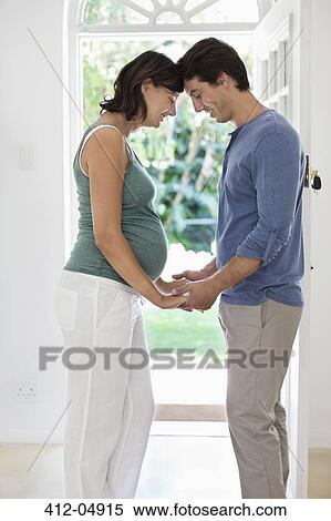 Man holding pregnant girlfriend's hand View Large Photo Image Stock Photography - Man holding pregnant girlfriend's hand. Fotosearch