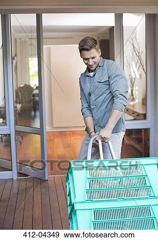 Stock Photo - Man making deliveries on front porch. Fotosearch