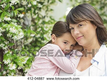 Mother carrying daughter outdoors View Large Photo Image Stock Photo - Mother carrying daughter outdoors. Fotosearch