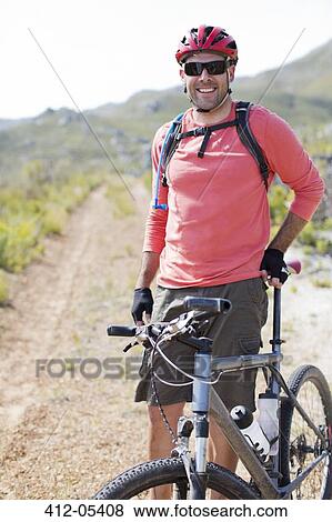 mountain biker smiling on dirt path View Large Photo Image Stock Photo - mountain biker smiling on dirt path. Fotosearch