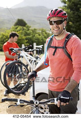 Picture - mountain biker smiling outdoors. Fotosearch