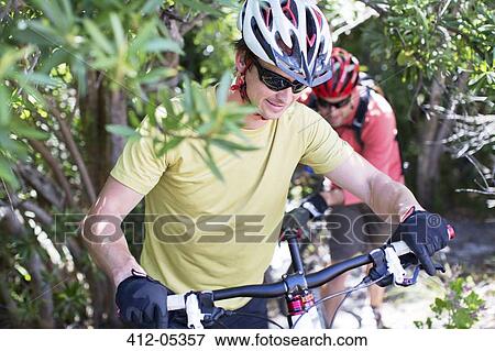 Stock Photo - mountain bikers in rural landscape. Fotosearch