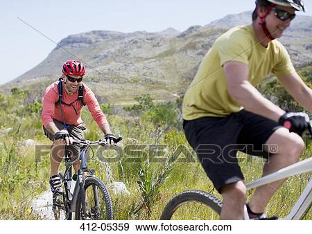 Stock Photo - mountain bikers on dirt path. Fotosearch
