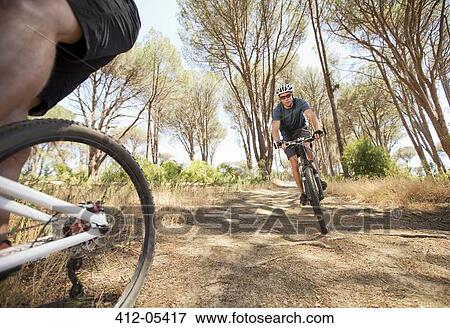 Stock Photo - mountain bikers on dirt path. Fotosearch
