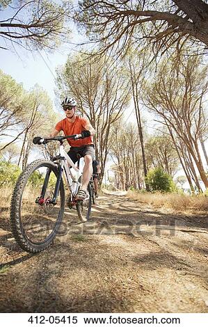 Stock Photography - mountain bikers on dirt path. Fotosearch