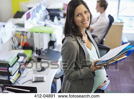 Pregnant businesswoman working in office View Large Photo Image Stock Image - Pregnant businesswoman working in office. Fotosearch