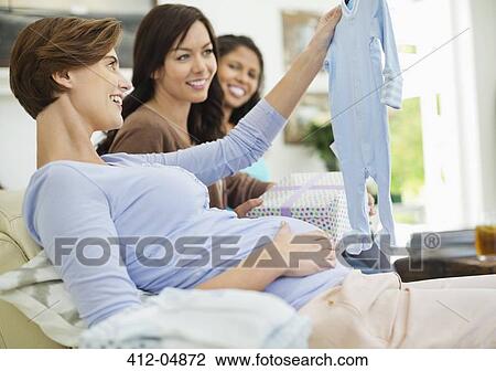 Stock Image - Pregnant woman having baby shower. Fotosearch