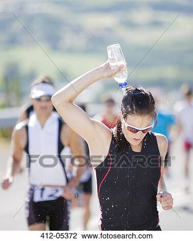 Runner pouring water on head in race View Large Photo Image Stock Image - Runner pouring water on head in race. Fotosearch