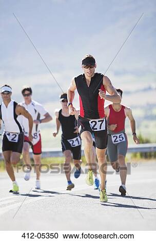Stock Image - Runners in race on rural road. Fotosearch