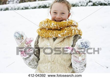Smiling girl playing in snow View Large Photo Image Stock Image - Smiling girl playing in snow. Fotosearch